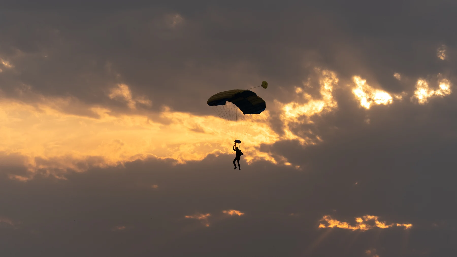 Tandem skydiver in freefall over the coastline